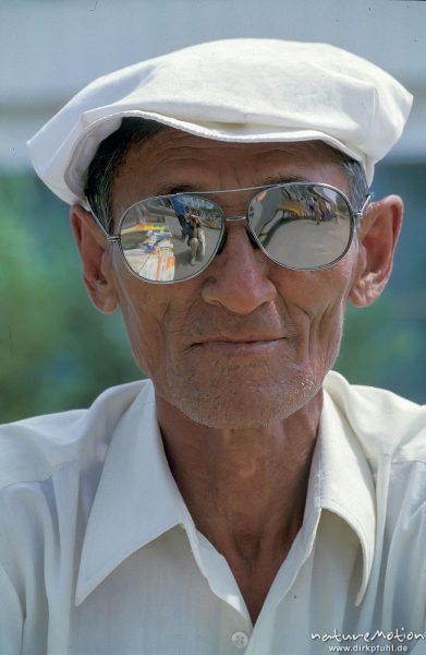 alter Mann mit weißer Schrimmütze und verspiegelter Sonnenbrille, Buchverkäufer auf der Straße, Ulaanbaatar - Ulan Bator, Mongolei